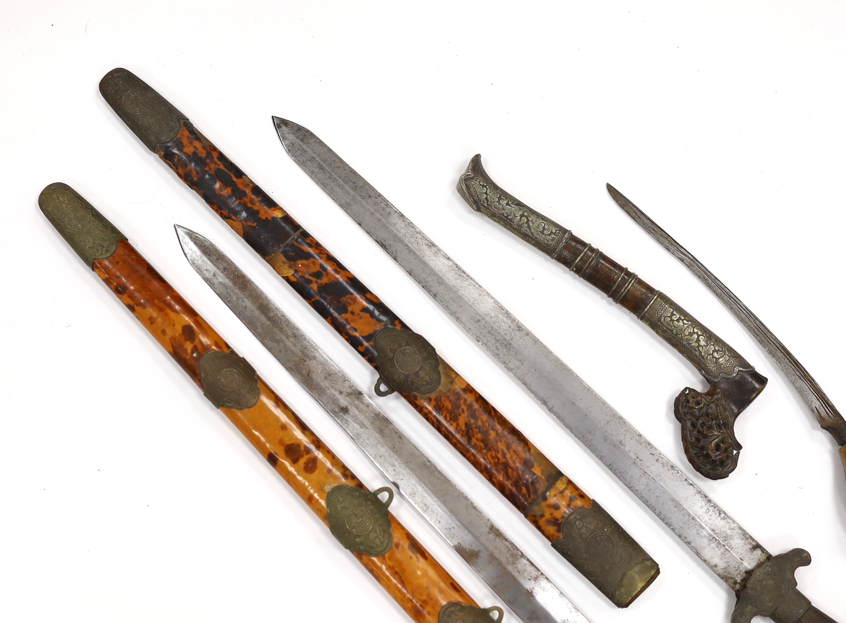 Two Chinese short swords (Jian) in faux tortoiseshell veneered scabbards and a Sumatran knife dagger with sheath (sekin), blade 42cm